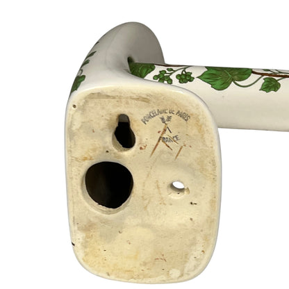 Ceramic bracket with leafdesign and 'Paris Porcelain' branding on a white background