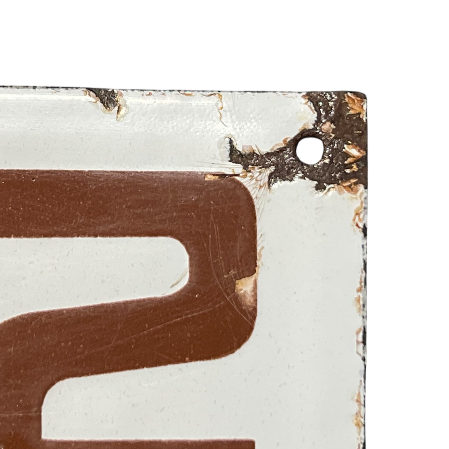 Close-up of a brown number 2 on a white background with a textured border.