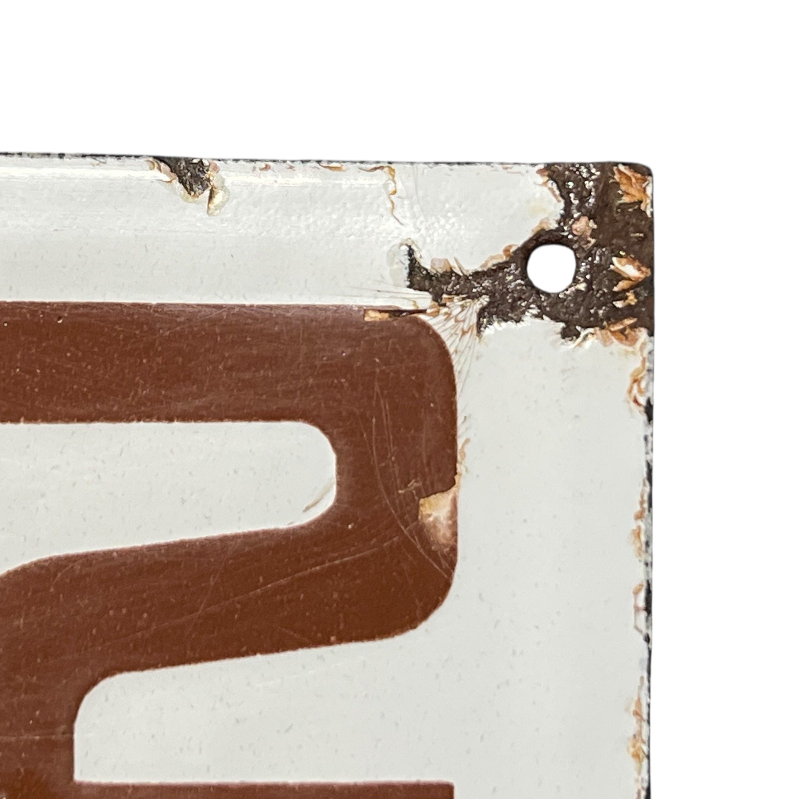 Close-up of a brown number 2 on a white background with a textured border.