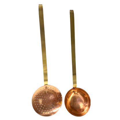 Set of 2 French copper utensils with long brass handles, includes a straining spoon and a ladle on a white background