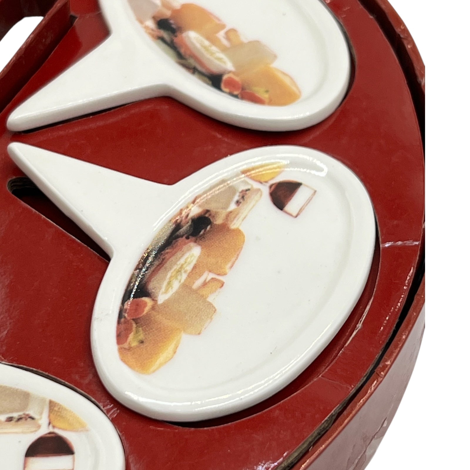 Close up of a porcelain cheese label in a red box on a white background