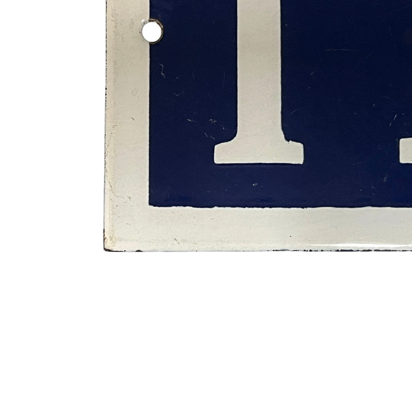 Close-up of a blue sign with white number 118 on a white background
