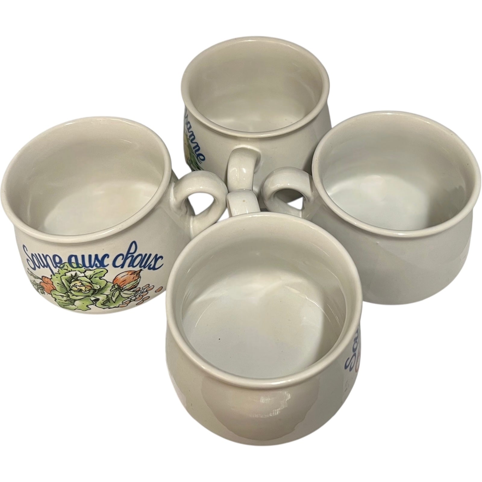 Set of four ceramic cups with soup design on a white background