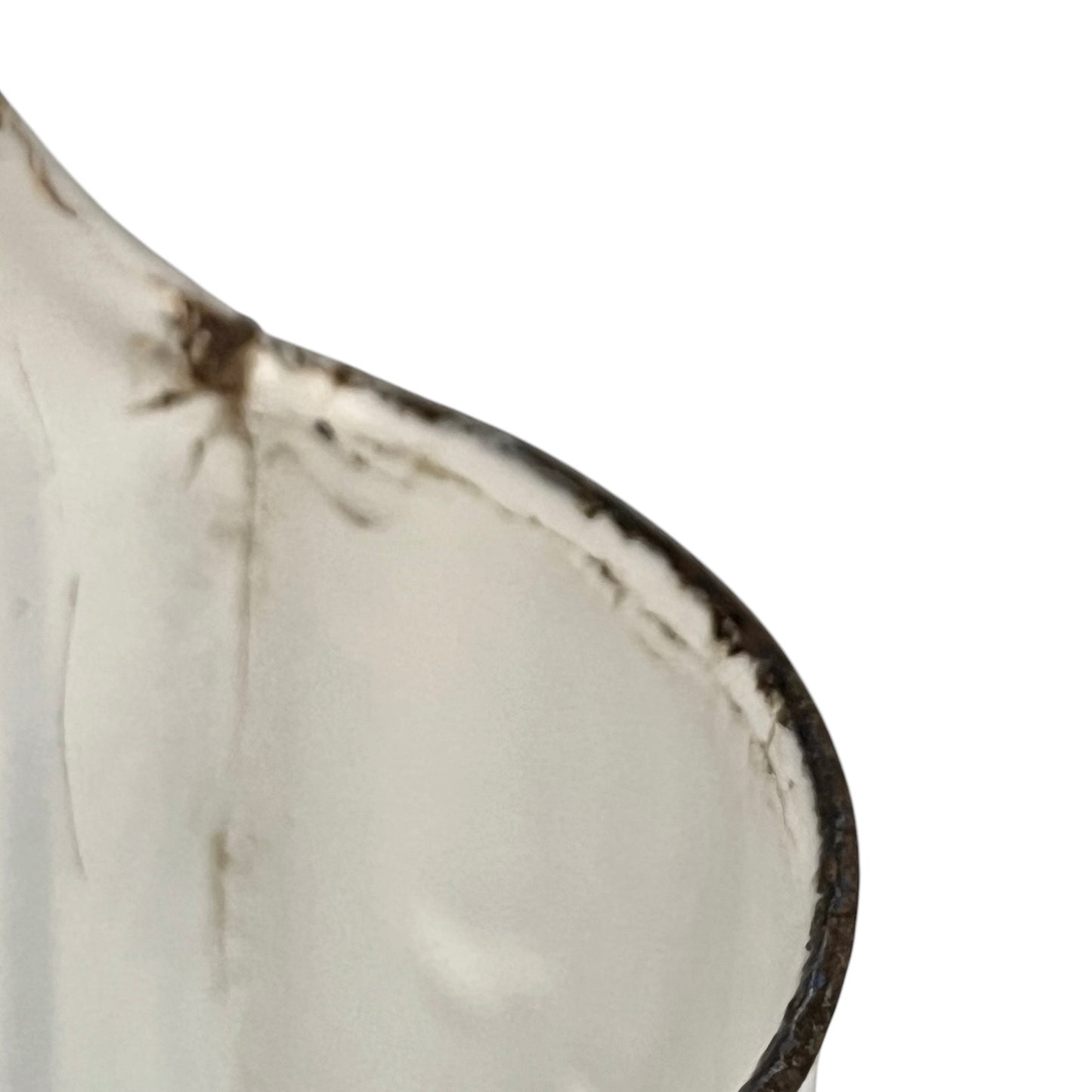 Close up of a vintage French enamel irrigator