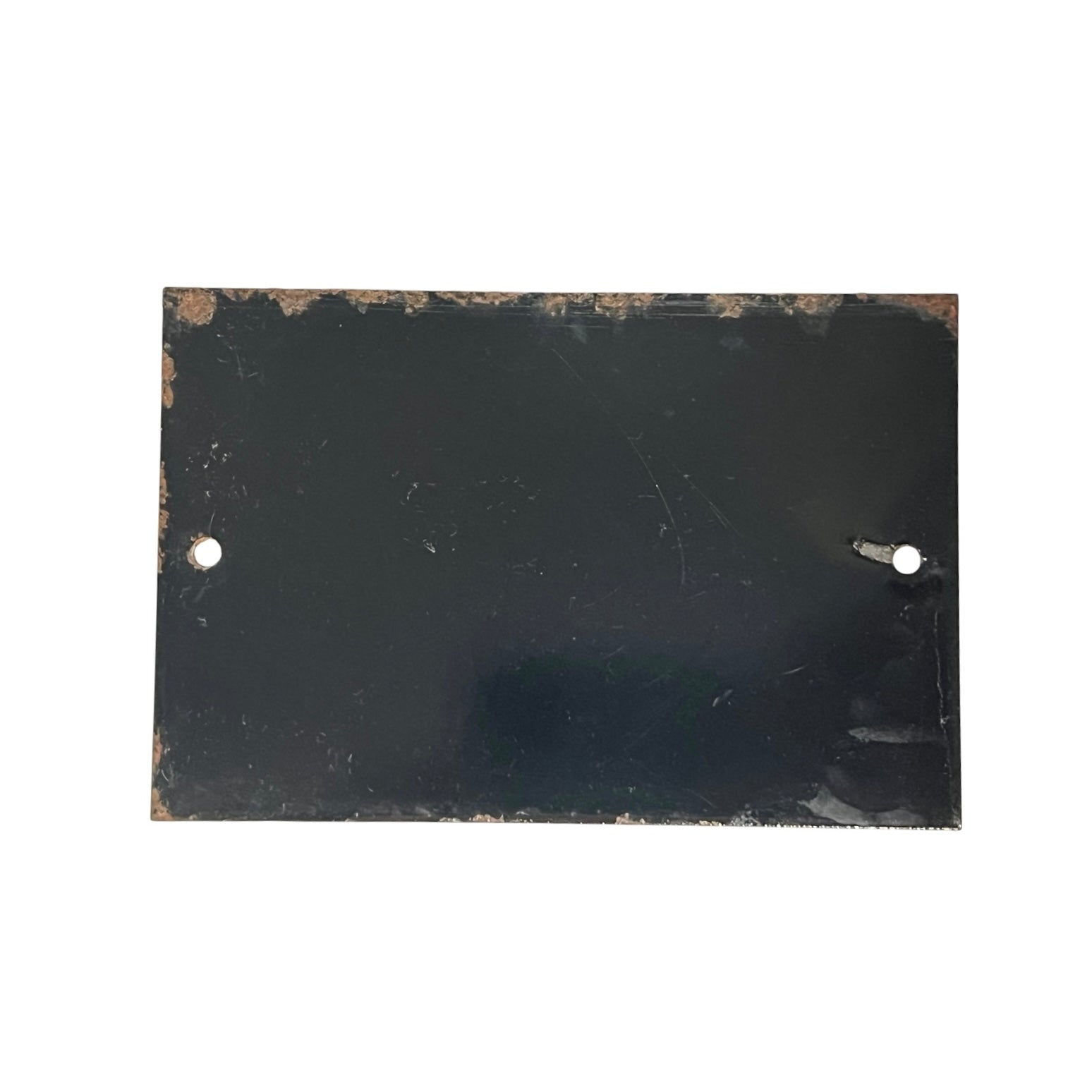 A rectangular black metal plate with two pre-drilled holes on the left and right sides, featuring a distressed, weathered finish with rust-like brown markings along the edges, shown against a plain white background.