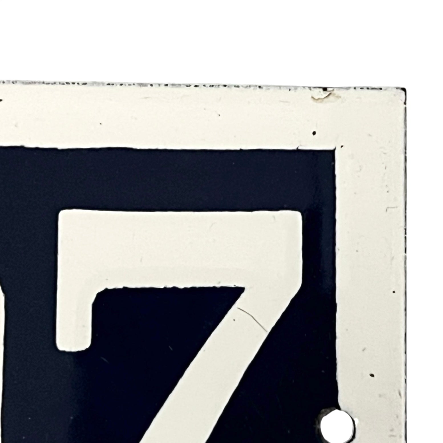 Close-up of a white number '7' on a dark background