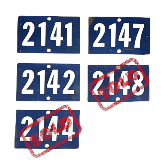 Set of blue number plates with red crossed-out numbers on a white background