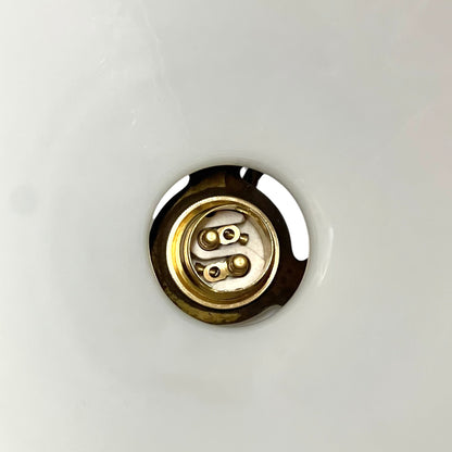 close up of brass ceiling light fixture with white glass shade on a white background