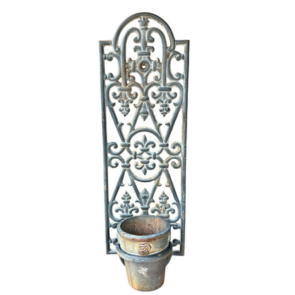 Decorative cast iron French vintage metal wall art with a planter pot on white background