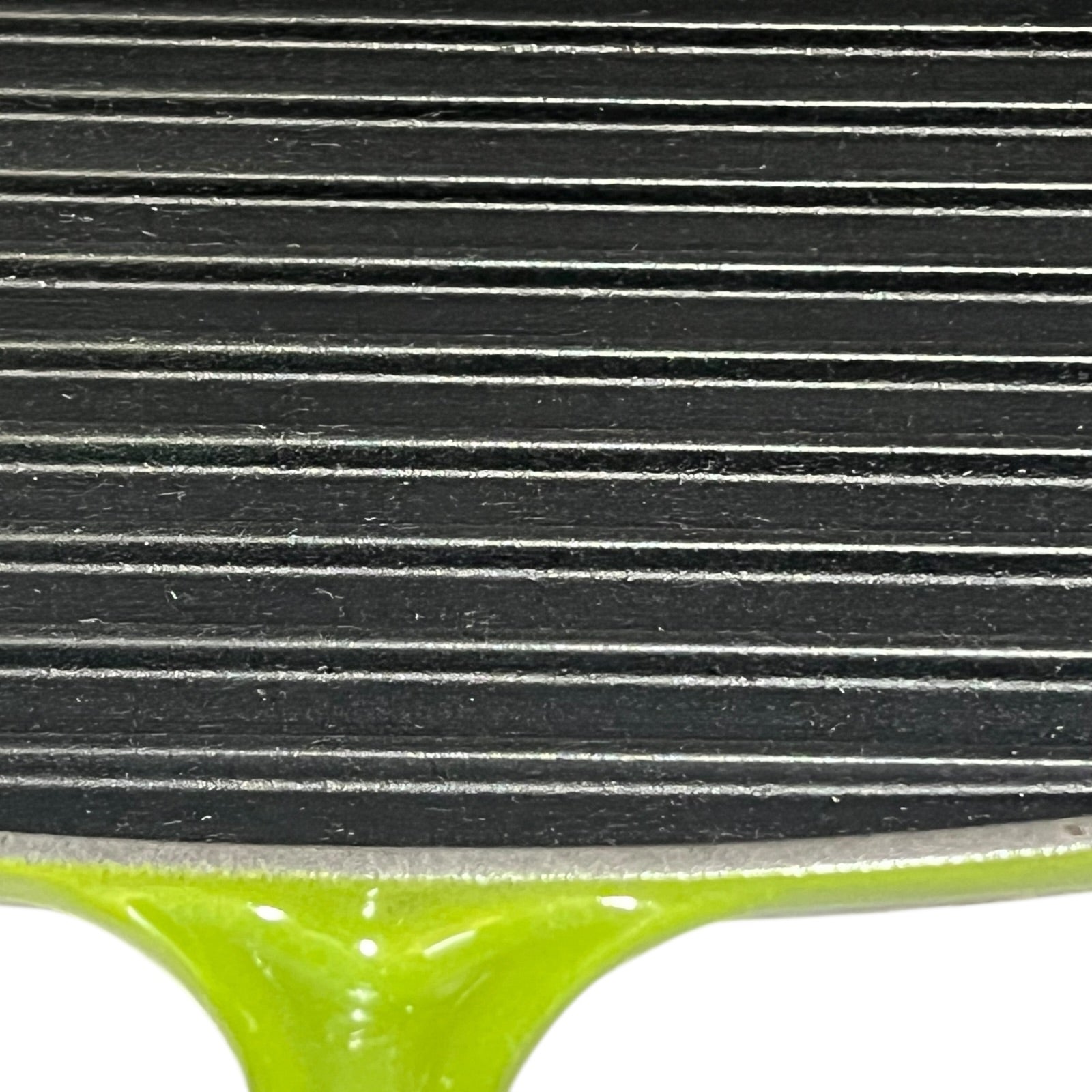 Close-up of a black cast iron skillet with ribbed surface