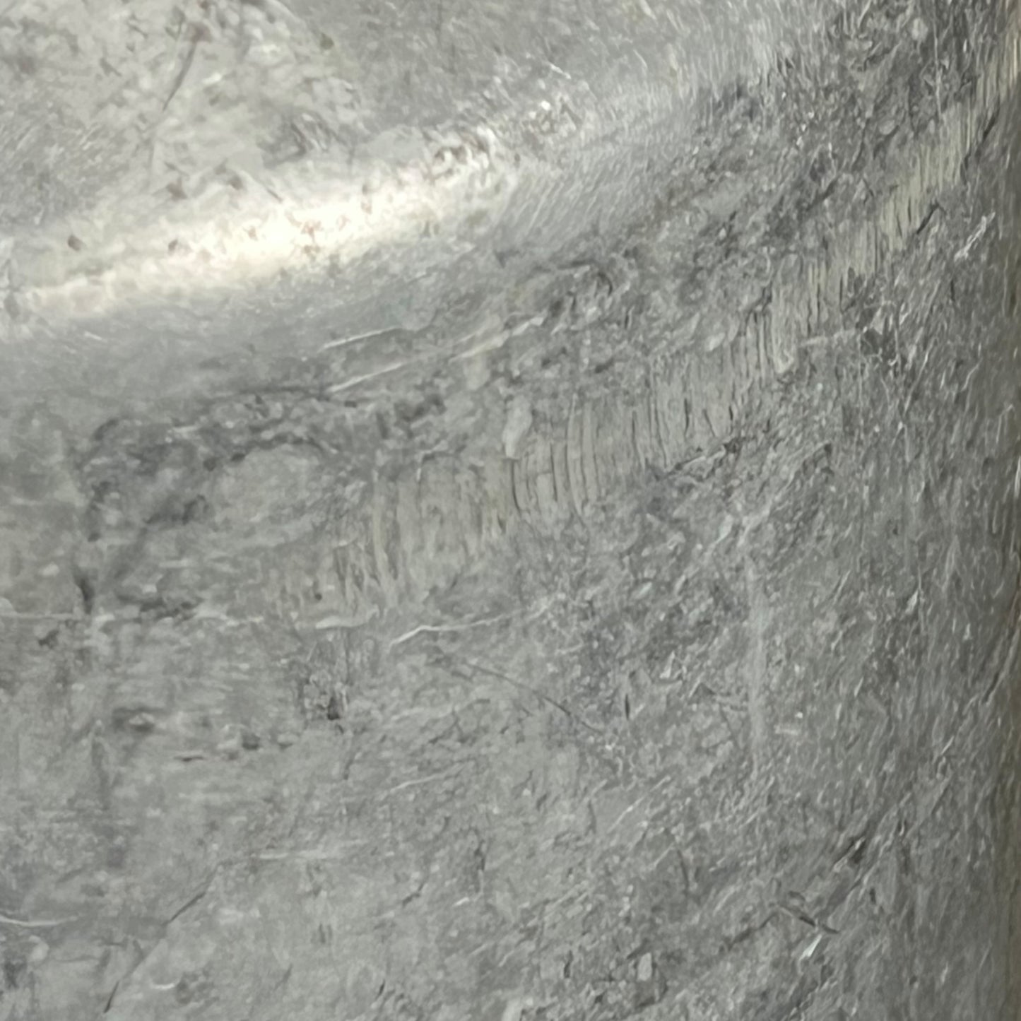 close up of metal milk churn on a white background