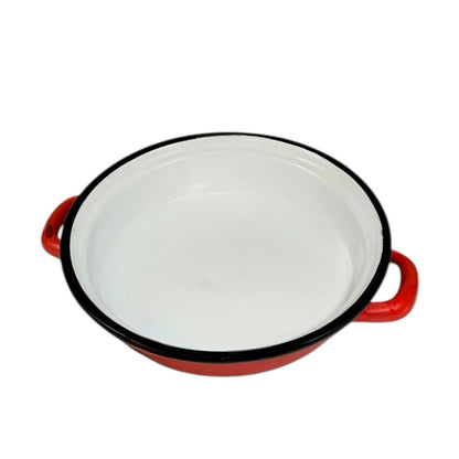 Red enamelled French vintage skillet with black rim on a white background