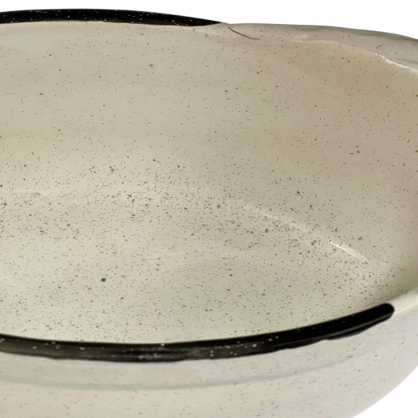 Close-up of a beige ceramic dish with speckled texture