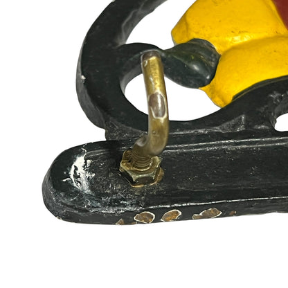 Close-up of a cast iron tea towel hook on a white background
