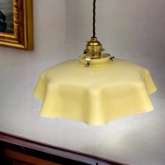 Vintage- French pendant light with a yellow glass shade on a white wall for sale from All Things French Store