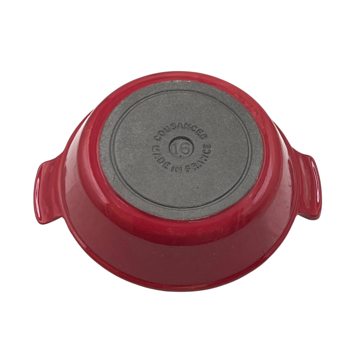 A red enameled cast iron casserole dish shown from its bottom side, displaying a dark gray non-stick coating and embossed 'Cousances' branding, on a solid white background.