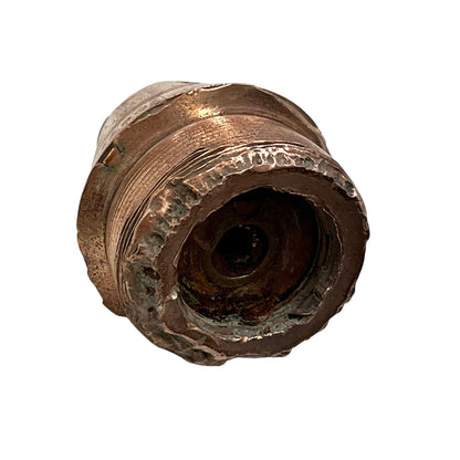 WW1 brass fuse paperweight on a white background