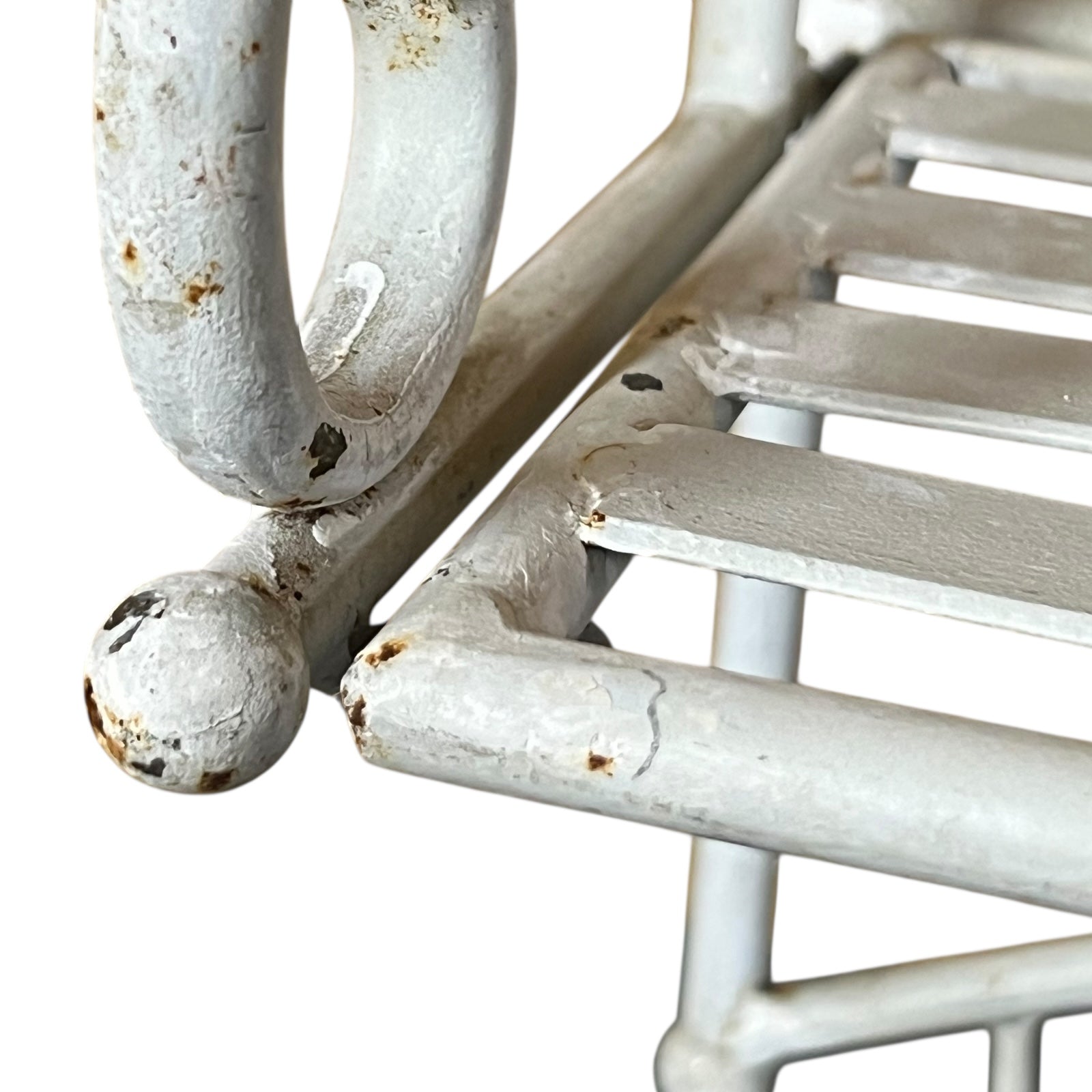 Close-up of a white metal shelf with visible wear and tear on a white background
