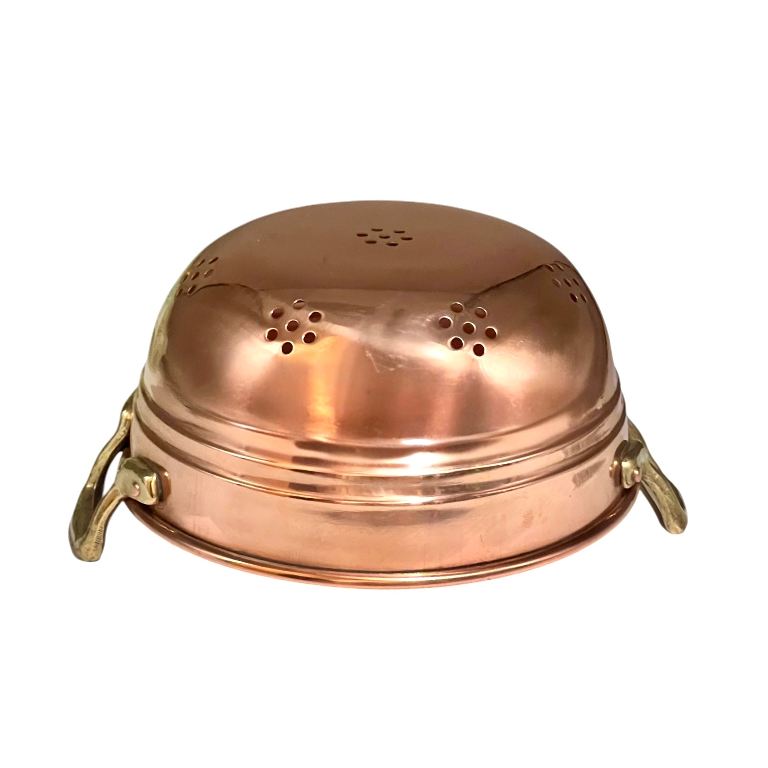 A copper colander with a domed lid, featuring multiple drainage holes on the top and sides, and two brass handles on the sides, shown against a plain white background.
