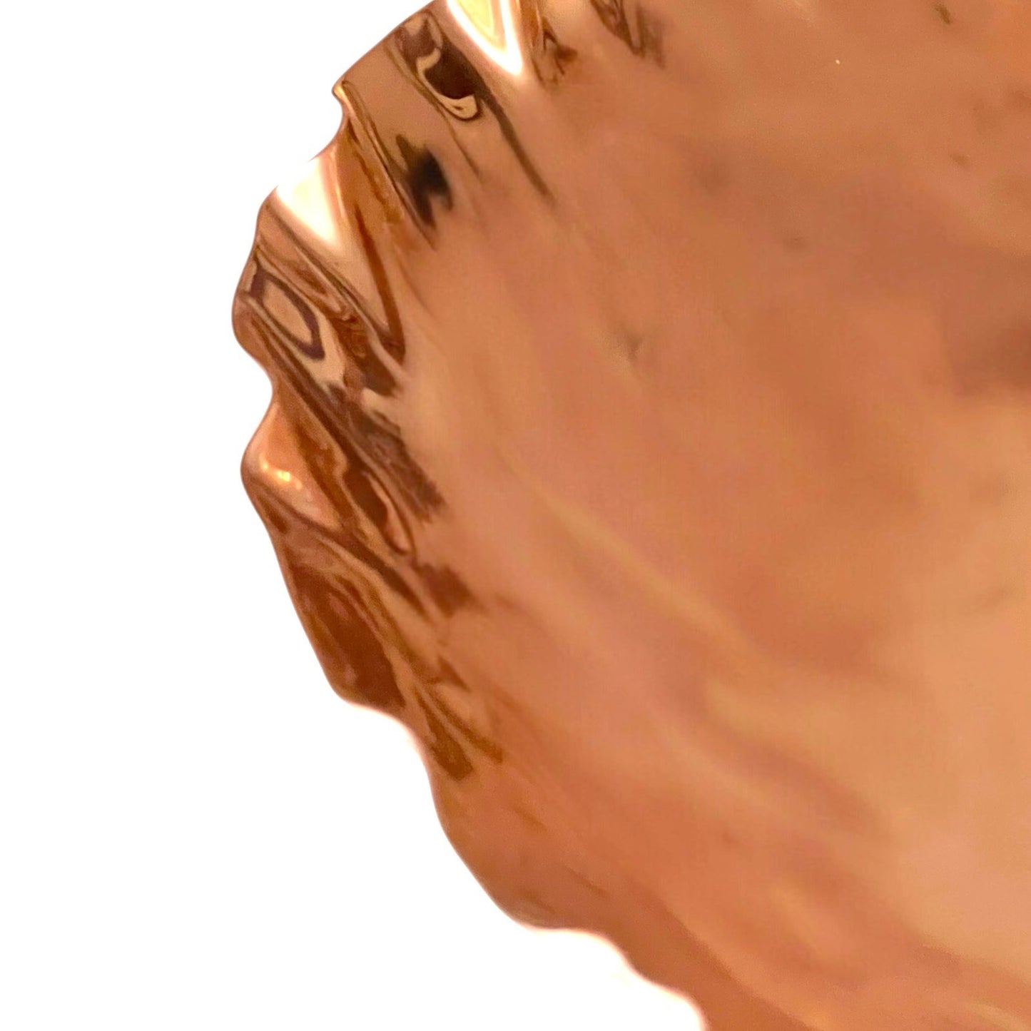 Close-up of a copper fruit bowl on a white background