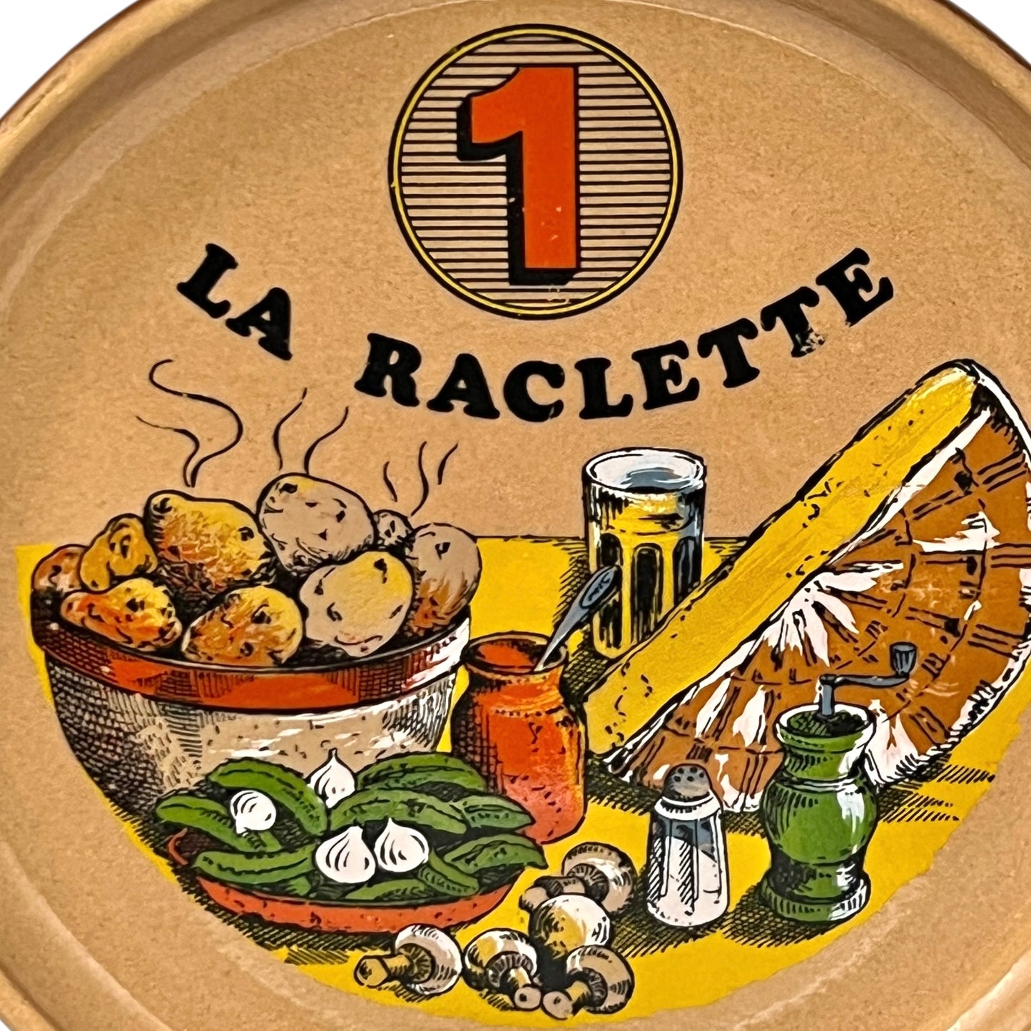 Plate with 'La Raclette' branding, the number 1 and illustrations on a white background