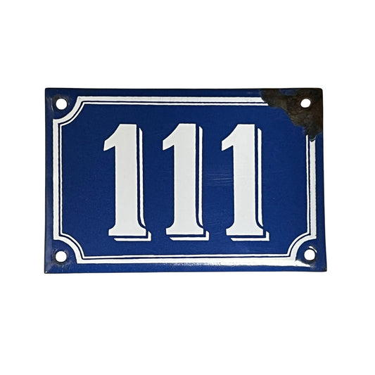 Vintage blue and white French enamel door number 111 ideal for a vintage home, set on a white background