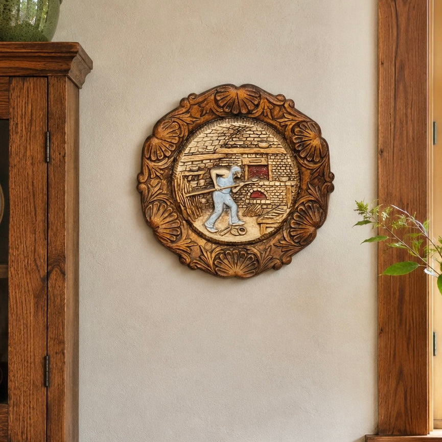 French vintage circular raised 3d wood resin wall plaque on a wall in a rustic kitchen with a wooden cabinet and a vase with greenery