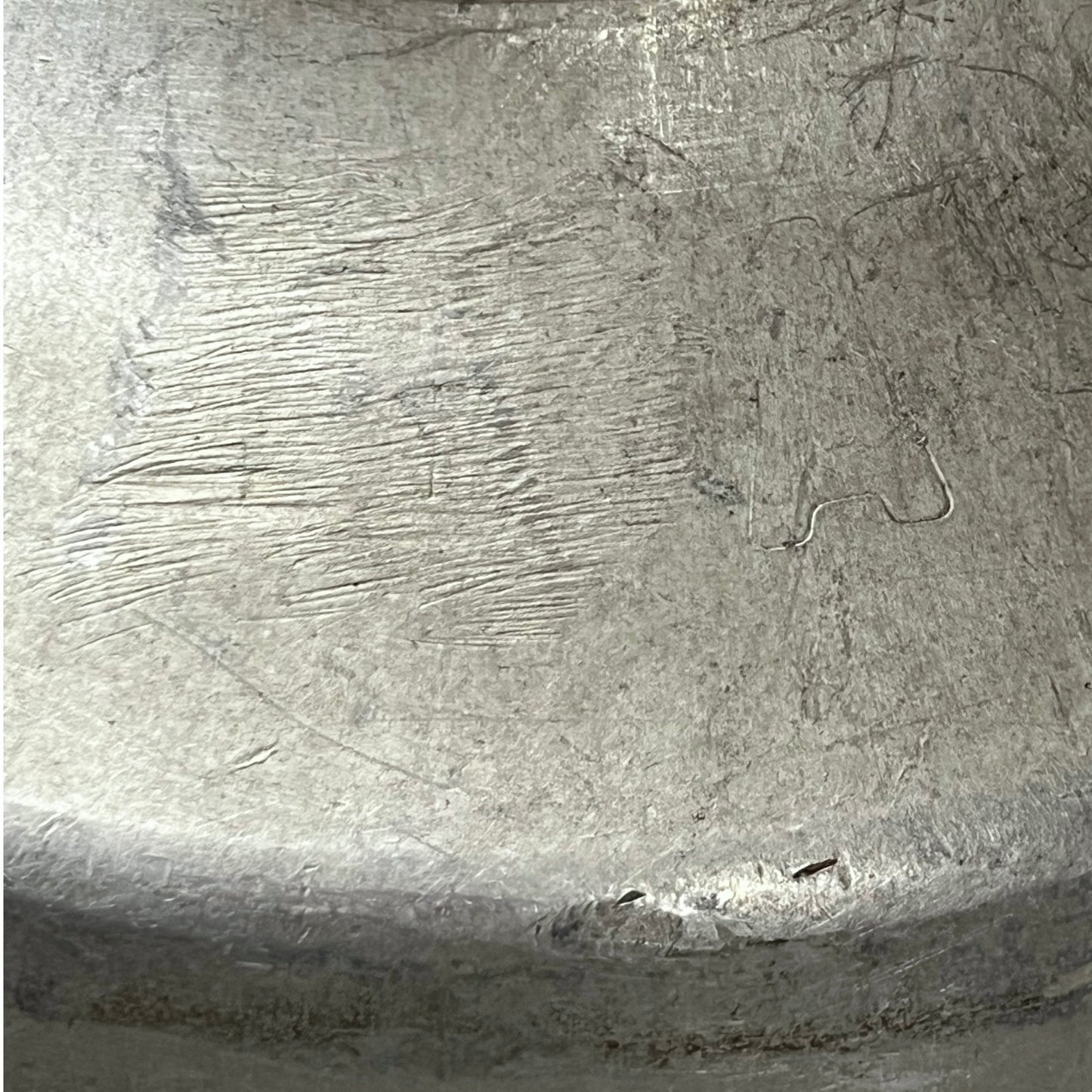 Close-up of a textured metal surface with engraved patterns