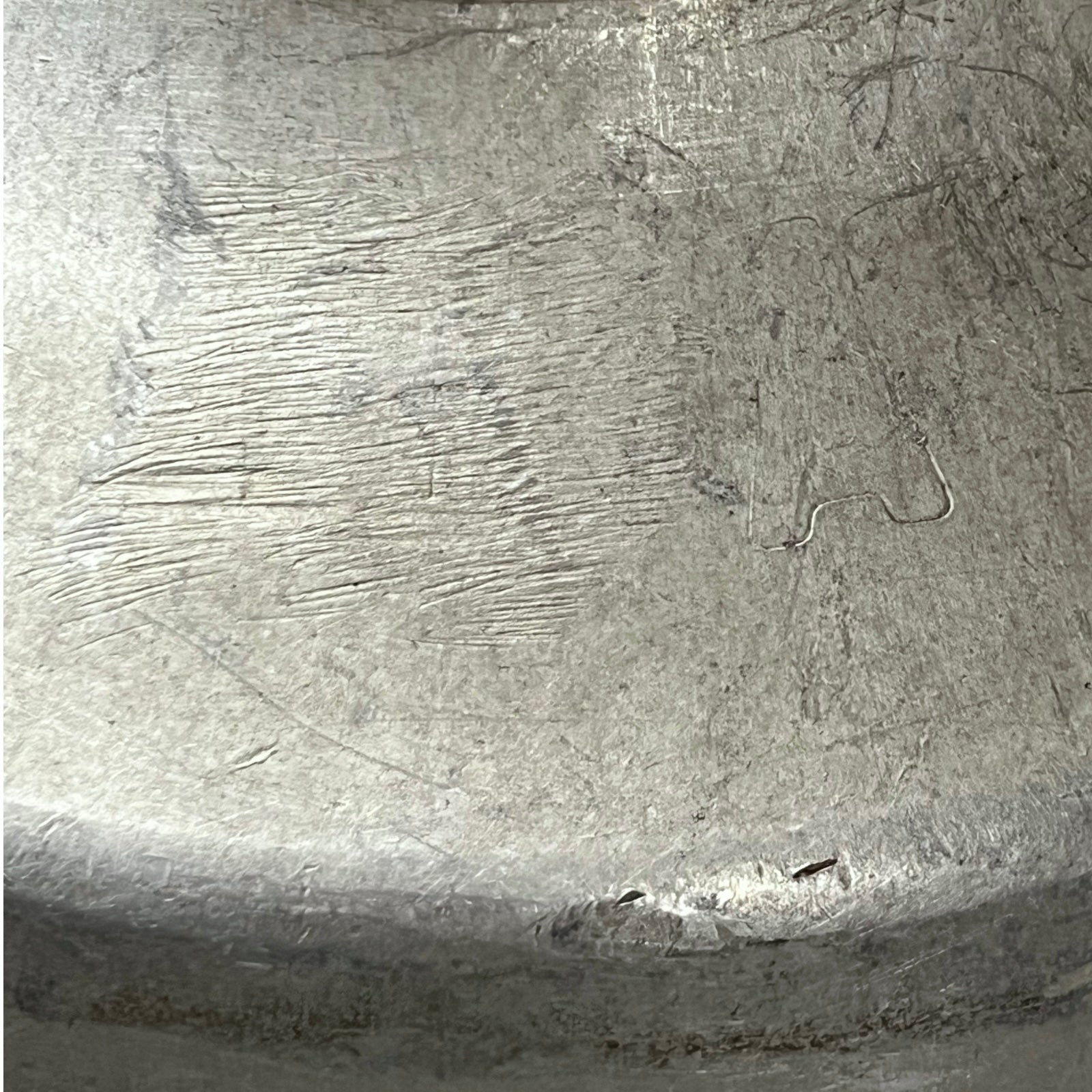 Close-up of a textured metal surface with engraved patterns