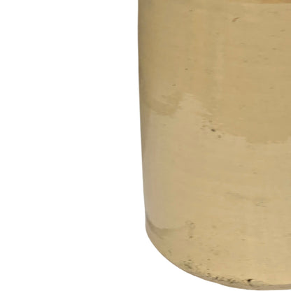 Close up of a beige cylindrical WW1 jar on a white background