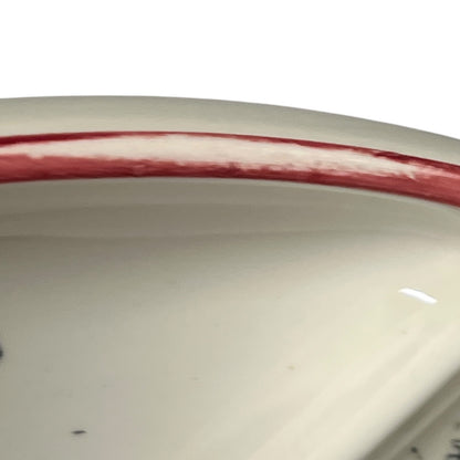 Close-up of a vintage fondue plate with detailed design on a white background