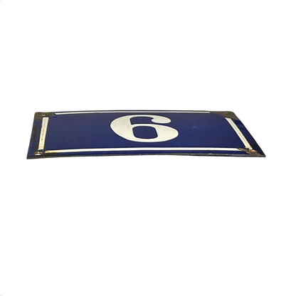 A rectangular blue sign with a large white number 6 in the center, bordered by a thin white line and metal mounting corners, shown on a plain white background.