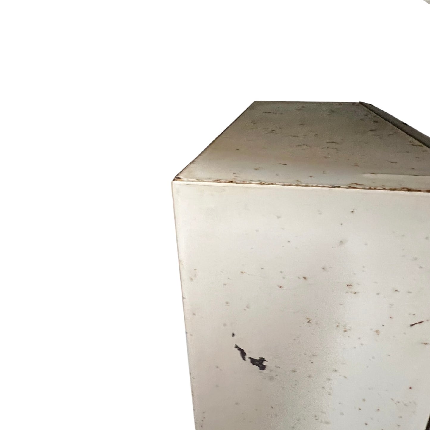 close up of a vintage metal bathroom cabinet on a white background