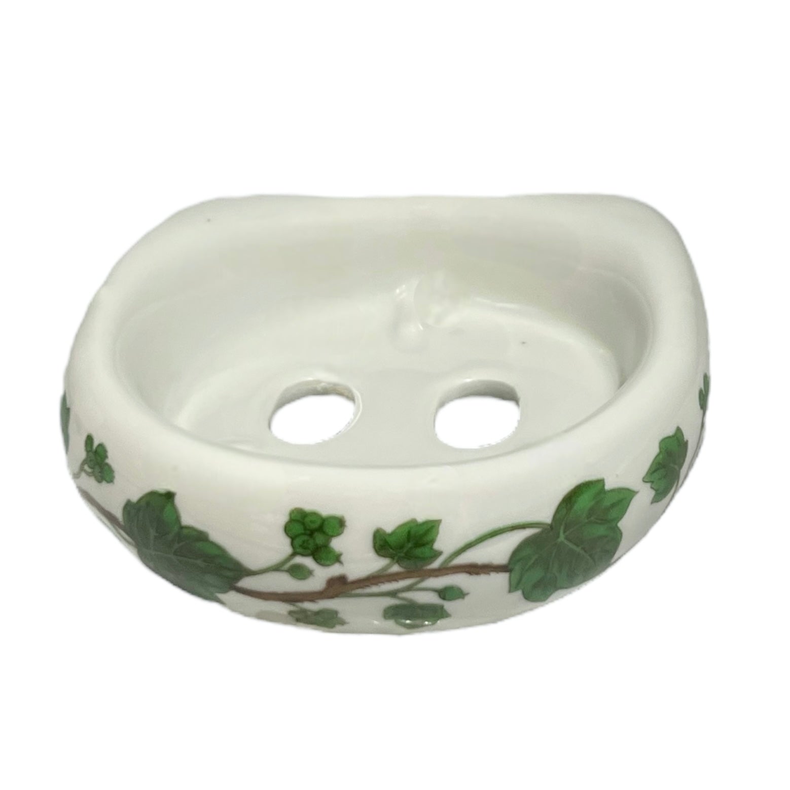 Porcelain bathroom toothbrush holder  featuring green leaf patterns on a white background