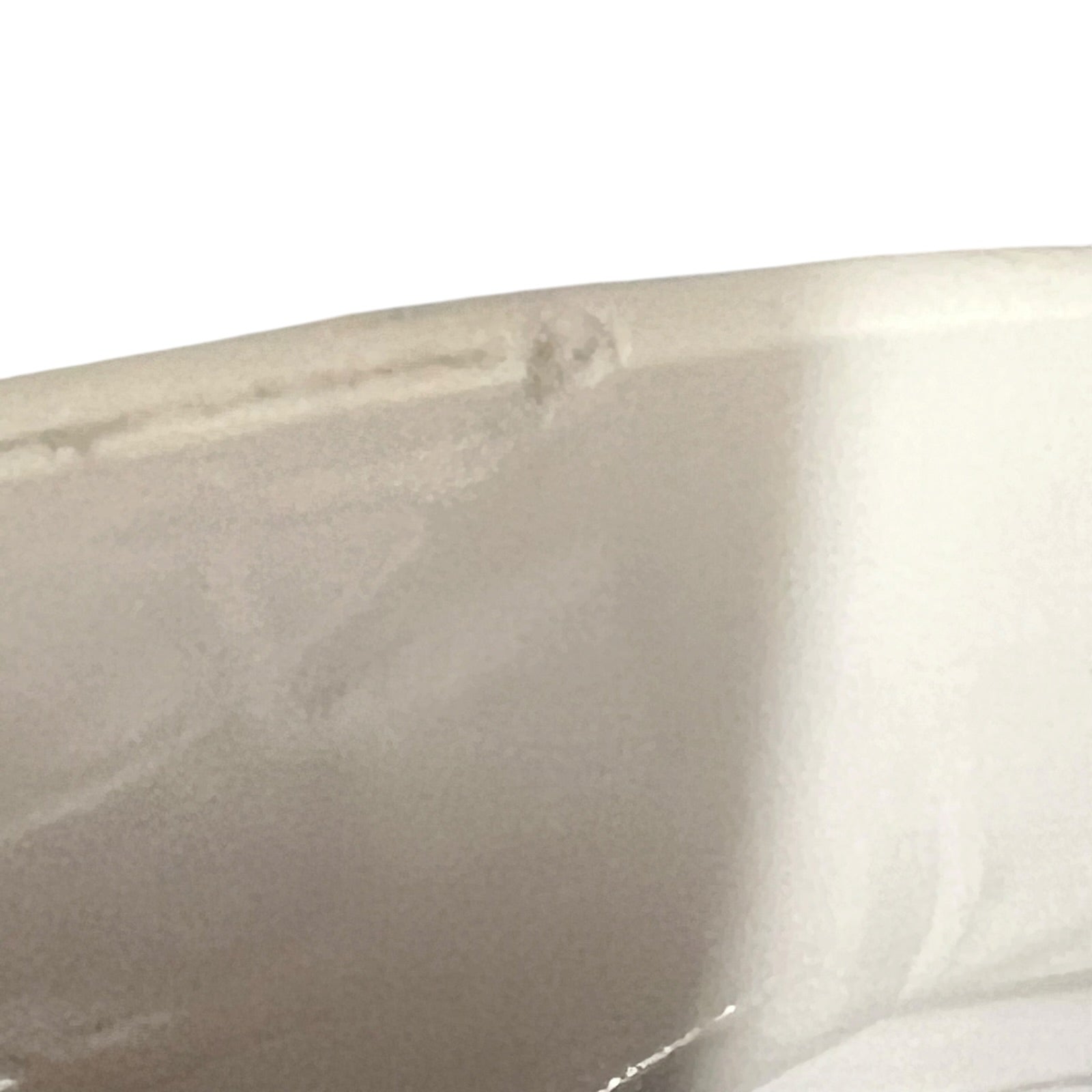 Close-up of a beige ceramic sink with a white background