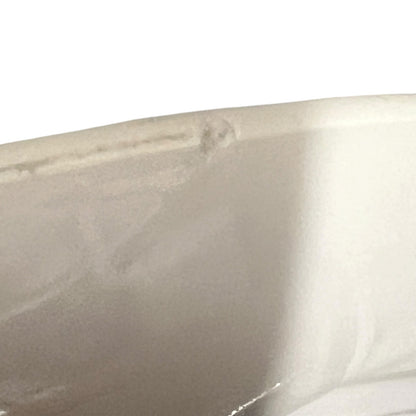 Close-up of a beige ceramic sink with a white background