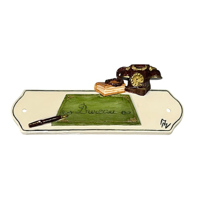 Decorative novelty door sign for an office labelled in French as Bureau, with a telephone, book and pan decoration on a white background