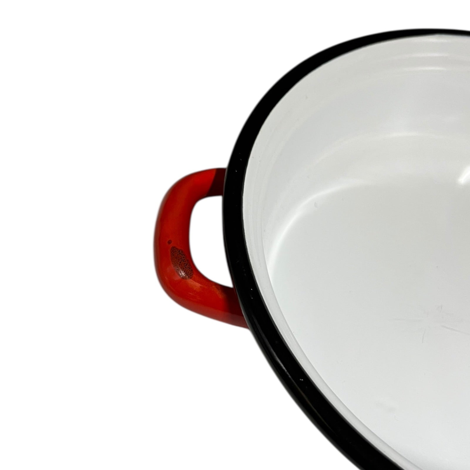 Close-up of a red enamel skillet on a white background