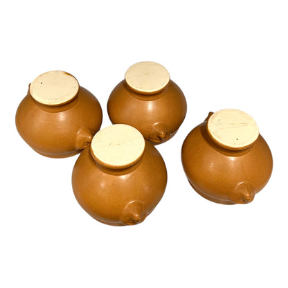 light brown ceramic French soup bowls with lions head handles on a white background 