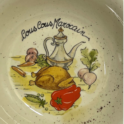 Decorative plate with illustrations of food and 'Couscous Marocain' text on a speckled background.