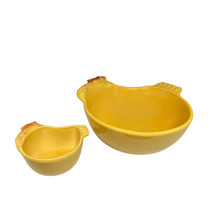 Two yellow ceramic chicken-shaped bowls, one small and one large, shown on a plain white background.