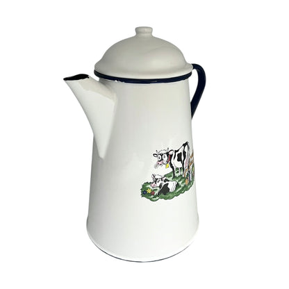 White enamel coffee pot with cow design on a white background