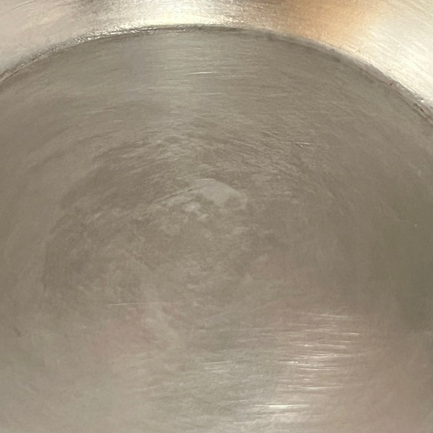 close up of French copper round gratin pan with brass handles and tin lining on a white background