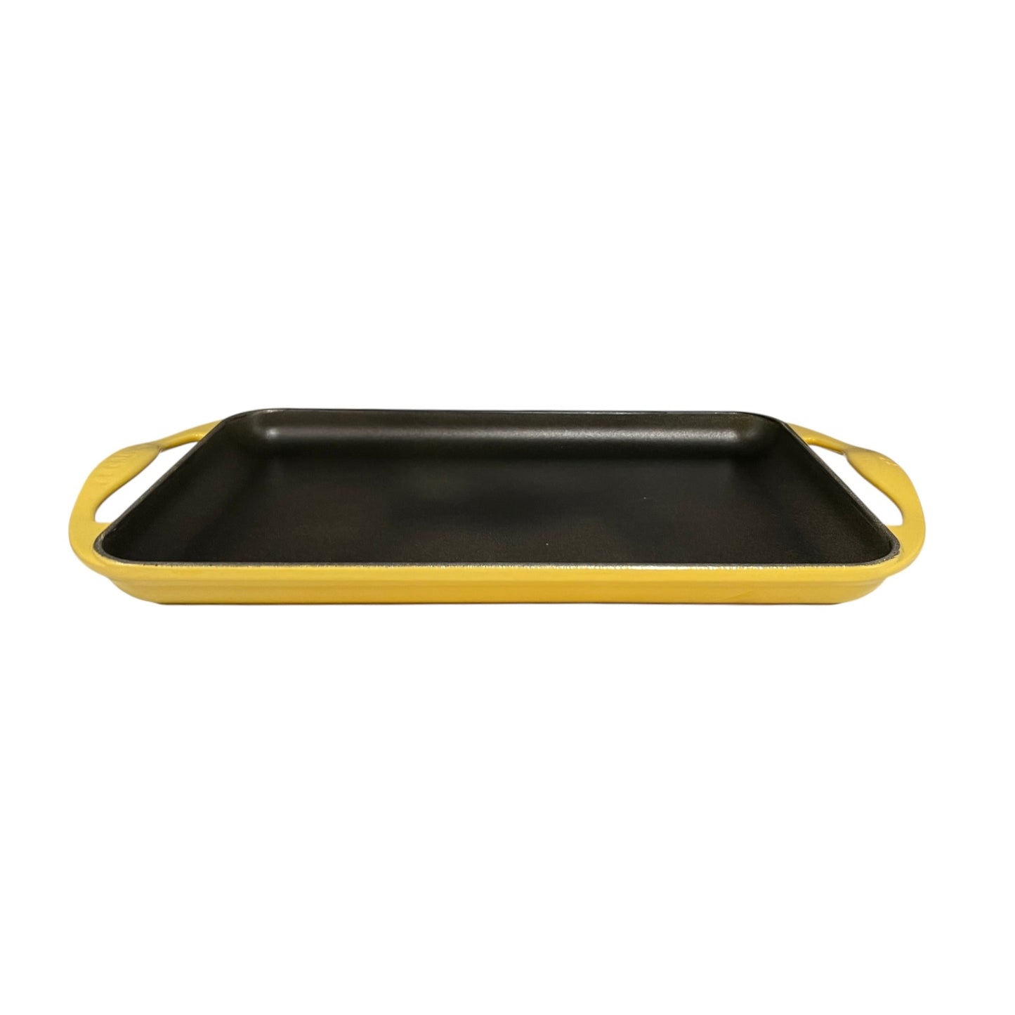 Le Cresuet griddle pan with yellow handles on a white background