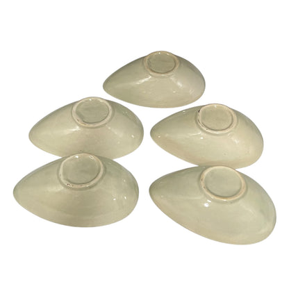 Beige ceramic dish with floral design and 'L'avocat' text on a white background