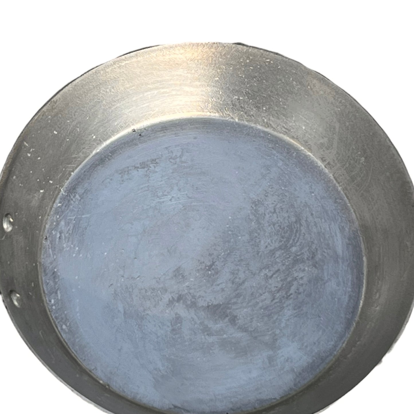 Tin lined inner of a French copper frying pan on a white background 