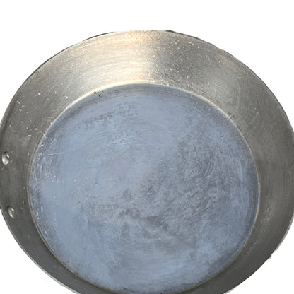 Tin lined inner of a French copper frying pan on a white background 