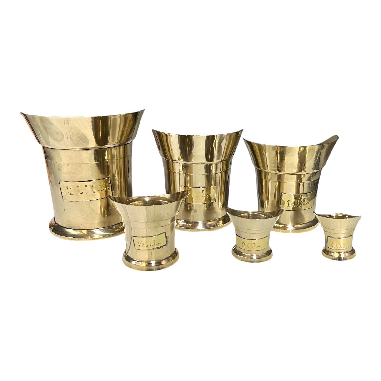 Set of brass tumblers on a white background