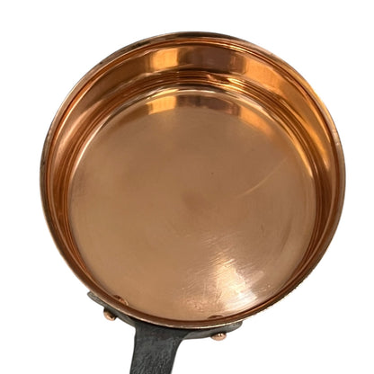 Copper-bottomed pan on a white background