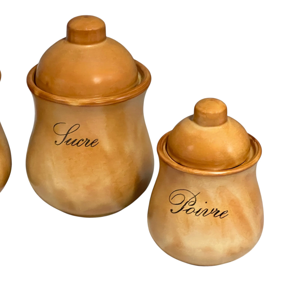 Two ceramic canisters with matching lids, one larger and one smaller, in warm tan and brown tones. The larger canister is labeled 'Sucre' and the smaller canister is labeled 'Poivre' in black cursive script, set against a plain white background.